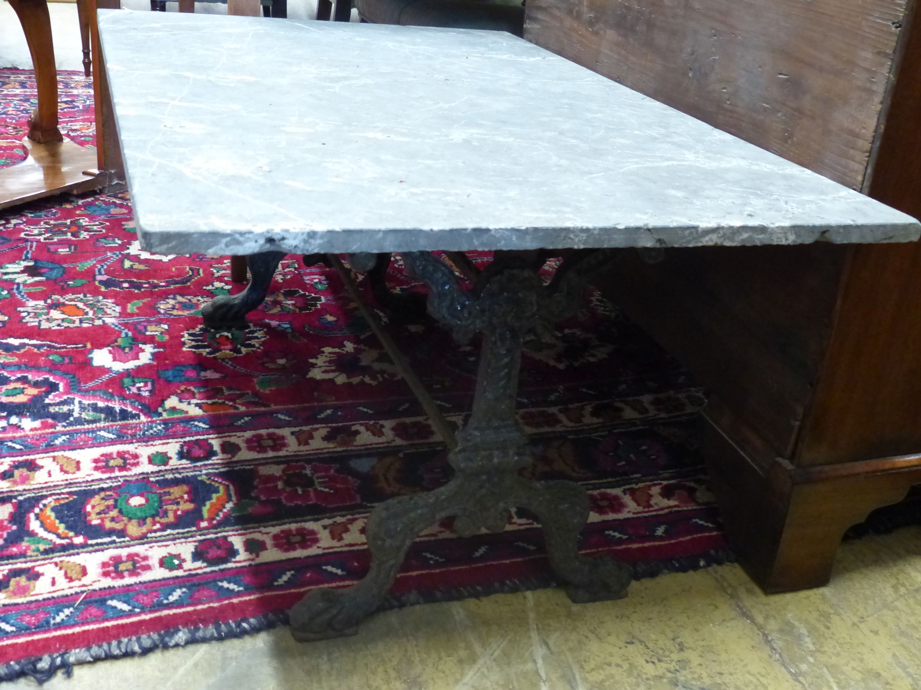 A rectangular marble top cast iron coffee table, width 108cm, depth 71cm, height 50cm